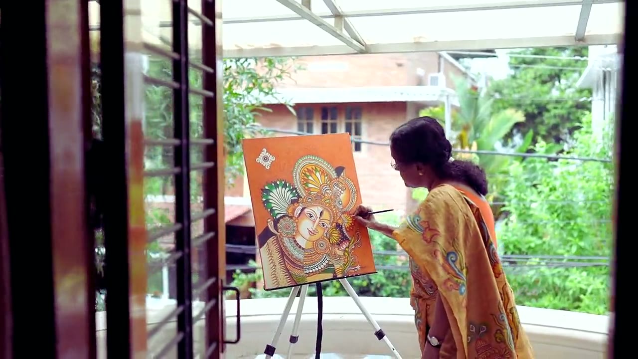 Dr. Manju P painting a Kerala mural in her studio